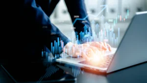 Businessperson using laptop with financial holograms, illustrating Lake Lanier market outlook 2025