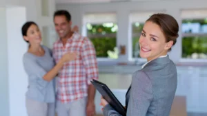 Smiling agent with a happy couple, showing guidance and confidence in Lake Lanier real estate