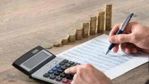 Man calculating lakefront home expenses and maintenance costs for Lake Lanier properties