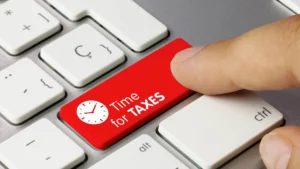 Keyboard key labeled Time for Taxes symbolizing property tax differences in Forsyth and Fulton County