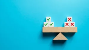 Wooden balance with check marks on one side and cross marks on the other, highlighting pros and cons