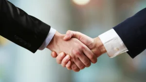 Handshake symbolizing trusted guidance from The Happy Homes Team in North Atlanta