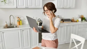 Woman coordinating moving services online and by phone using North Atlanta real estate moving tips