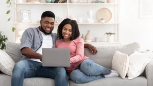 Couple researching neighborhoods and local services online before moving to North Atlanta suburbs