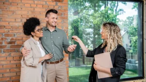Happy North Atlanta homebuyers touring a house and discussing options with their trusted real estate agent during the buying process