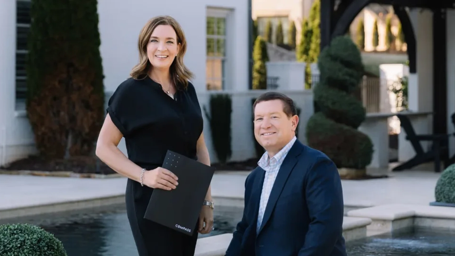 Real estate agents Gretchen Evans and Matt Tuck of The Happy Homes Team smiling together as trusted local North Atlanta Real Estate Experts