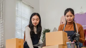 Women packing boxes efficiently as part of a North Atlanta moving checklist for smooth relocation