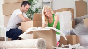 Couple unloading belongings into their new North Atlanta home following moving checklist steps